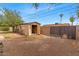 A fenced backyard with shed and neutral rock for low maintenance in the home's outdoor space at 1179 E Cordova Ave, Casa Grande, AZ 85122