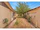 A spacious side yard with brick pavers enhances functionality with storage, leading to the backyard at 1179 E Cordova Ave, Casa Grande, AZ 85122
