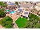 Aerial shot showing a private pool, expansive green lawn, and a home equipped with solar panels at 1203 W Escuda Rd, Phoenix, AZ 85027