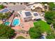 Aerial view showcasing the backyard with a pool, green lawn, solar panels, and outdoor living spaces at 1203 W Escuda Rd, Phoenix, AZ 85027