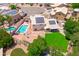 Home with a pool, beautifully landscaped backyard, complete with solar panels, and mature trees at 1203 W Escuda Rd, Phoenix, AZ 85027