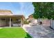 Backyard patio featuring a covered hot tub, picnic table, and grill, ideal for outdoor entertaining and relaxation at 1203 W Escuda Rd, Phoenix, AZ 85027