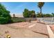 Desert landscaped backyard featuring an outdoor play area and mature trees for shade and privacy at 1203 W Escuda Rd, Phoenix, AZ 85027