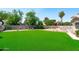 Expansive backyard with lush artificial grass, perfect for entertaining and outdoor activities at 1203 W Escuda Rd, Phoenix, AZ 85027