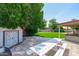 Backyard with shed, picnic table, hot tub and artificial grass, perfect for outdoor relaxation and activities at 1203 W Escuda Rd, Phoenix, AZ 85027