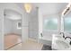 Bright ensuite bathroom features a glass shower, tub, window and a double vanity plus an archway to the bedroom at 1203 W Escuda Rd, Phoenix, AZ 85027