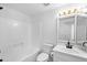 Bright bathroom featuring a shower-tub combo, white vanity with mirror, and modern fixtures at 1203 W Escuda Rd, Phoenix, AZ 85027