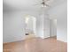 Bright bedroom featuring wood floors, ceiling fan, and archway entrance to an ensuite bathroom at 1203 W Escuda Rd, Phoenix, AZ 85027