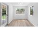 Versatile bonus room featuring wood flooring, natural light, and backyard access at 1203 W Escuda Rd, Phoenix, AZ 85027