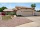 Inviting home featuring desert landscaping, a tile roof, and a two-car garage for ample parking at 1203 W Escuda Rd, Phoenix, AZ 85027