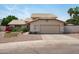 Charming home exterior with a well-maintained yard, desert landscaping, and a spacious two-car garage at 1203 W Escuda Rd, Phoenix, AZ 85027