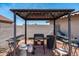 Backyard gazebo featuring a grill, seating, and lighting, perfect for outdoor cooking and entertaining at 1203 W Escuda Rd, Phoenix, AZ 85027