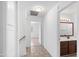 Hallway with tile flooring leading to a bedroom and bathroom, featuring modern lighting at 1203 W Escuda Rd, Phoenix, AZ 85027