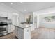 Modern kitchen with stainless steel appliances, granite countertops, white cabinets, and center island at 1203 W Escuda Rd, Phoenix, AZ 85027