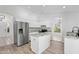 Modern kitchen with white cabinets, stainless steel appliances, granite countertops and a central island at 1203 W Escuda Rd, Phoenix, AZ 85027