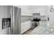 Kitchen with stainless steel refrigerator, white cabinetry, and modern countertops for a stylish design at 1203 W Escuda Rd, Phoenix, AZ 85027