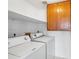 Functional laundry room with washer, dryer, and overhead cabinets for convenient storage and organization at 1203 W Escuda Rd, Phoenix, AZ 85027