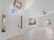Bright living room featuring tile flooring, a modern light fixture, and a large window at 1203 W Escuda Rd, Phoenix, AZ 85027