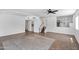 Spacious living room with tile flooring, neutral paint, staircase, and a ceiling fan at 1203 W Escuda Rd, Phoenix, AZ 85027