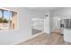 Bright loft area with wood floors, white walls, and a view of the kitchen at 1203 W Escuda Rd, Phoenix, AZ 85027