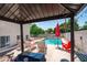 Resort-style backyard featuring a sparkling pool, lounge chairs, and a shaded seating area for entertaining at 1203 W Escuda Rd, Phoenix, AZ 85027
