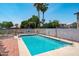 Private backyard pool with volleyball net, surrounded by a patio and lush landscaping, perfect for recreation at 1203 W Escuda Rd, Phoenix, AZ 85027