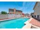 Backyard pool area with lounge chairs and volleyball net, perfect for outdoor enjoyment and relaxation at 1203 W Escuda Rd, Phoenix, AZ 85027
