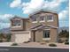 Beautiful two-story home featuring neutral stucco, well-maintained landscaping, and an attached two car garage at 15744 W Camden Ave, Waddell, AZ 85355