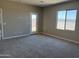 Inviting bedroom featuring carpet, large window, and natural light at 18180 W Larkspur Dr, Goodyear, AZ 85338