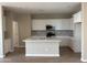 Modern kitchen with white cabinets, stainless steel appliances, and a center island at 18180 W Larkspur Dr, Goodyear, AZ 85338