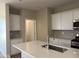 Bright kitchen featuring white cabinets, a spacious island, and stainless steel appliances at 18180 W Larkspur Dr, Goodyear, AZ 85338