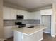 Well-equipped kitchen with an island, stainless steel microwave, and a gas range at 18180 W Larkspur Dr, Goodyear, AZ 85338