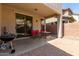 Covered back patio featuring red chairs and a table, with a grill off to the side at 18877 E Pelican Dr, Queen Creek, AZ 85142