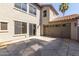 Spacious backyard featuring a large patio, stucco walls, and an attached garage at 18877 E Pelican Dr, Queen Creek, AZ 85142