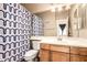 Bathroom featuring a shower with a patterned curtain, and wood cabinets with a sink at 18877 E Pelican Dr, Queen Creek, AZ 85142