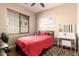 Cozy bedroom featuring wood floors, window with blinds, ceiling fan, and modern vanity at 18877 E Pelican Dr, Queen Creek, AZ 85142