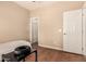 Minimalist bedroom with hardwood floors, neutral walls, and a simple bed, offering a peaceful and uncluttered space at 18877 E Pelican Dr, Queen Creek, AZ 85142
