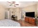 Comfortable main bedroom with hardwood floors, ceiling fan, a desk, and natural light, creating a relaxing atmosphere at 18877 E Pelican Dr, Queen Creek, AZ 85142