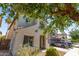 Two-story home with neutral stucco, gray shutters, a two-car garage, and mature landscaping at 18877 E Pelican Dr, Queen Creek, AZ 85142
