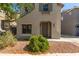 Two-story home showcasing a well-manicured front yard with decorative rock and shrubbery at 18877 E Pelican Dr, Queen Creek, AZ 85142