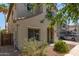 Two-story home with neutral stucco, gray shutters, a two-car garage, and mature landscaping at 18877 E Pelican Dr, Queen Creek, AZ 85142