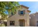 Charming two-story home with neutral stucco, gray shutters, and a well-maintained front yard at 18877 E Pelican Dr, Queen Creek, AZ 85142