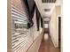 Hallway with hardwood floors featuring natural light through window blinds at 18877 E Pelican Dr, Queen Creek, AZ 85142