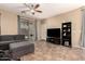 Cozy living room with a sectional sofa, entertainment center, and sliding glass doors leading to the outdoor space at 18877 E Pelican Dr, Queen Creek, AZ 85142