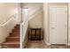 Inviting staircase featuring wood steps, white railings, and neutral walls, complemented by an ornate wooden cabinet at 18877 E Pelican Dr, Queen Creek, AZ 85142