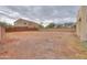 Expansive gravel backyard surrounded by neighboring homes and tall fencing at 2194 N Magdelena Pl, Casa Grande, AZ 85122
