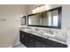 Bathroom featuring granite countertops with double vanity sinks and a large mirror at 2194 N Magdelena Pl, Casa Grande, AZ 85122