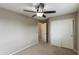 Neutral bedroom featuring a ceiling fan, closet, and access to connecting rooms at 2194 N Magdelena Pl, Casa Grande, AZ 85122