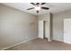 Comfortable bedroom with a ceiling fan and a closet with shelving and lighting at 2194 N Magdelena Pl, Casa Grande, AZ 85122