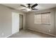 Bedroom with carpeted floor, slider closet doors, and window with blinds at 2194 N Magdelena Pl, Casa Grande, AZ 85122